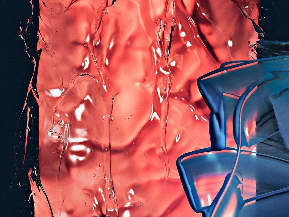 Abstract still life with translucent red resin and blue plastic forms, creating a play of light and shadow on a dark background.