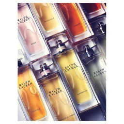 Overhead flat lay of multiple Ralph Lauren perfume bottles with coloured glass and visible brand text.