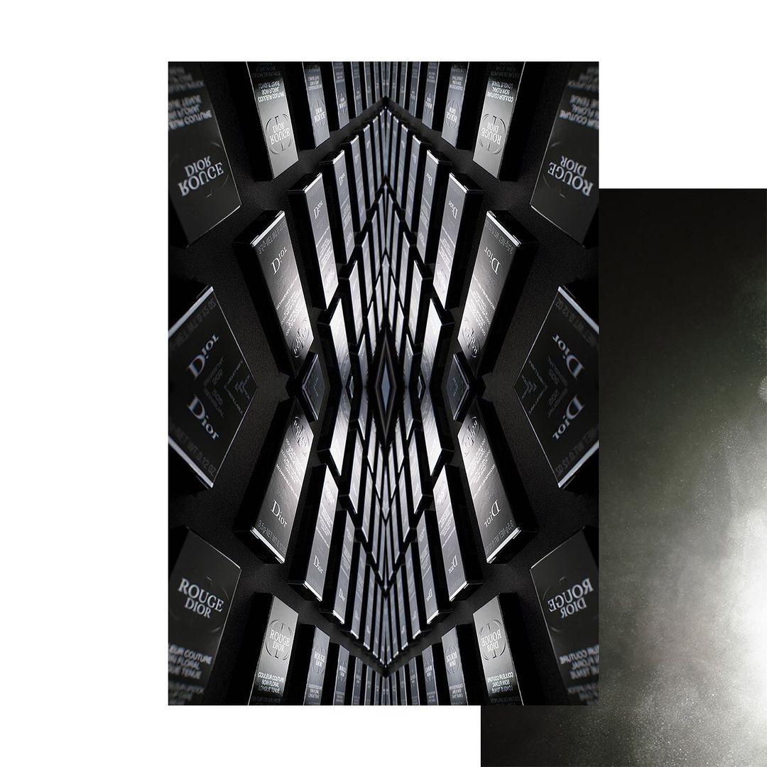 Abstract arrangement of Dior beauty products in a kaleidoscopic pattern against a dark background, conveying luxury and visual symmetry.