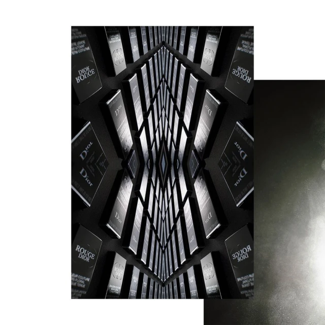 Abstract arrangement of Dior beauty products in a kaleidoscopic pattern against a dark background, conveying luxury and visual symmetry.