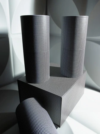 Geometric product shot featuring three cylinders and a rectangle covered in houndstooth pattern set against a white patterned background.