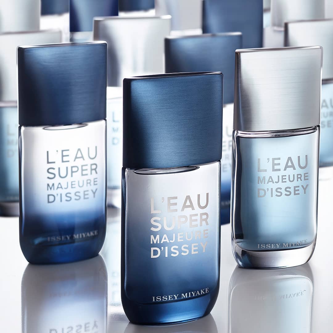 Product shot of L'Eau Majeure D'Issey and L'Eau Super Majeure D'Issey fragrances with cool blue and white color palette and reflective surface.