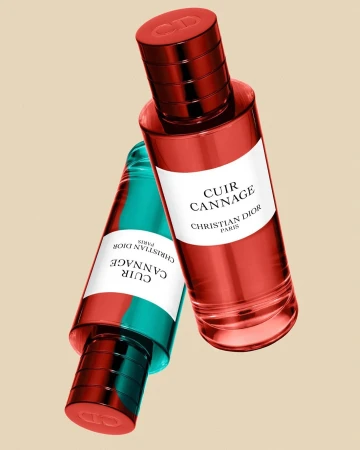 Two perfume bottles floating against a solid beige background, featuring red and turquoise glass with white labels.