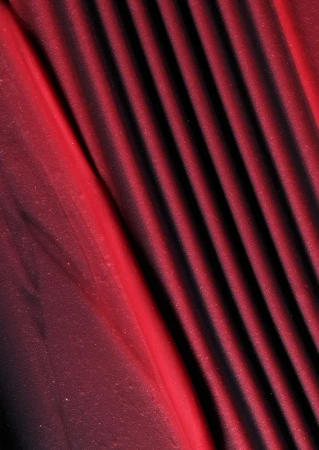 Burgundy textile fabric with diagonal pleats and a silky shimmer.