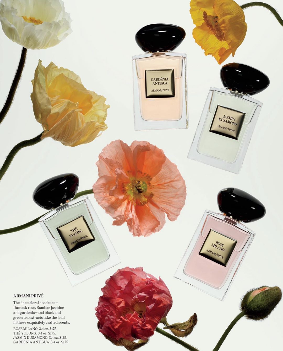 Assortment of Armani Prive perfume bottles with floral accents. Various fragrance bottles arranged with colorful flowers on a white surface.