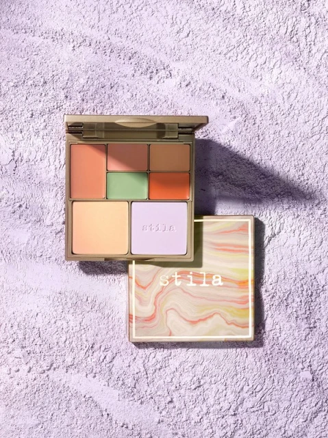 Stila Correct & Perfect Palette with multiple shades for color correction and concealing on textured lavender background, close-up.
