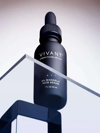Vivant skincare product bottle on a geometric glass and dark blue plastic stand against a soft gradient background, product still life.
