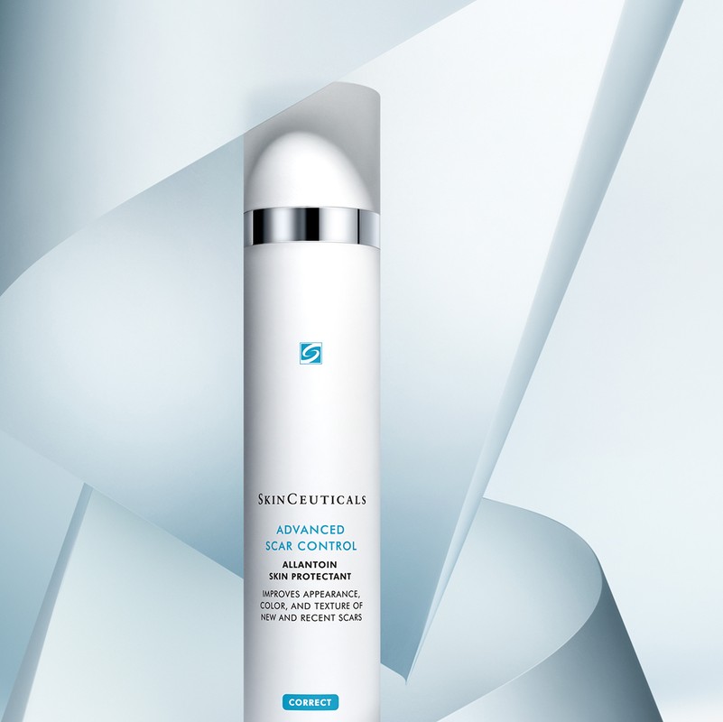 Elegant studio shot of SkinCeuticals Advanced Scar Control, an Allantoin skin protectant, against a light blue geometric backdrop.