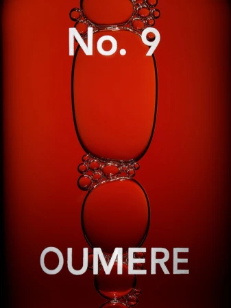 Abstract close-up of a series of red liquid bubbles, illuminated to reveal the forms, with text 'No. 9' and 'Oumere' overlaid.