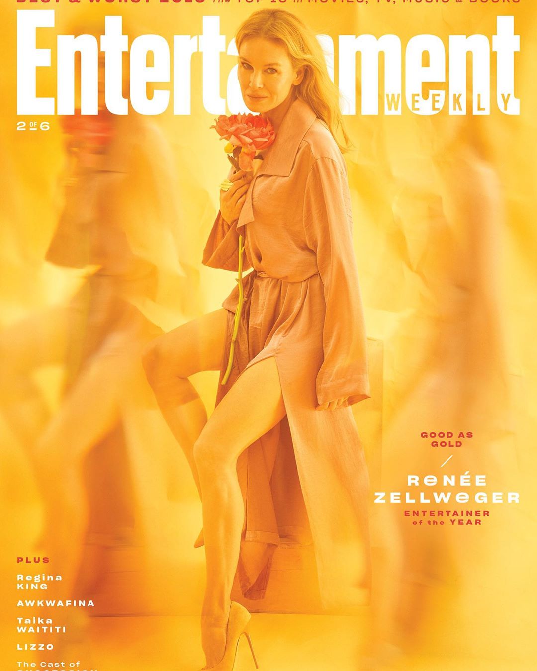 Renee Zellweger poses on a magazine cover with peach-colored roses in hand, wearing a flowing robe and heels, against a yellow backdrop.