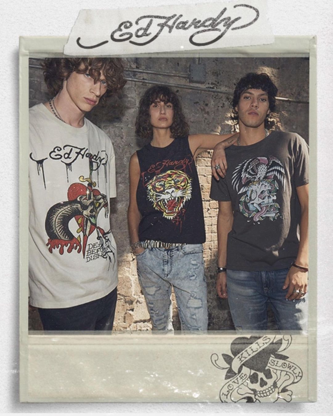 Three people wearing Ed Hardy t-shirts stand indoors against a concrete wall, posing in a faux-Polaroid style, fashion shot.