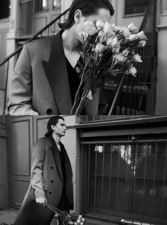 Monochrome diptych of a man in a double-breasted coat holding a large bouquet of roses on an outdoor stairway