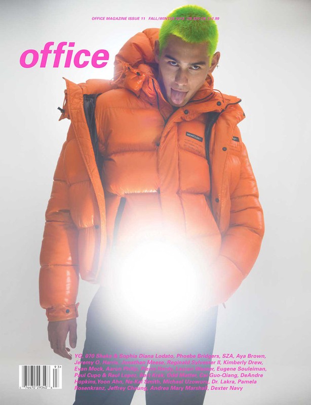 Magazine cover featuring a model with green hair and orange puffer jacket against a white background.