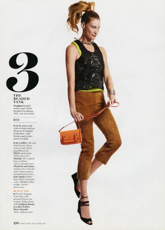 Fashion editorial shot of a woman with her hair in a high ponytail wearing a beaded top, brown capri pants, and black heels.