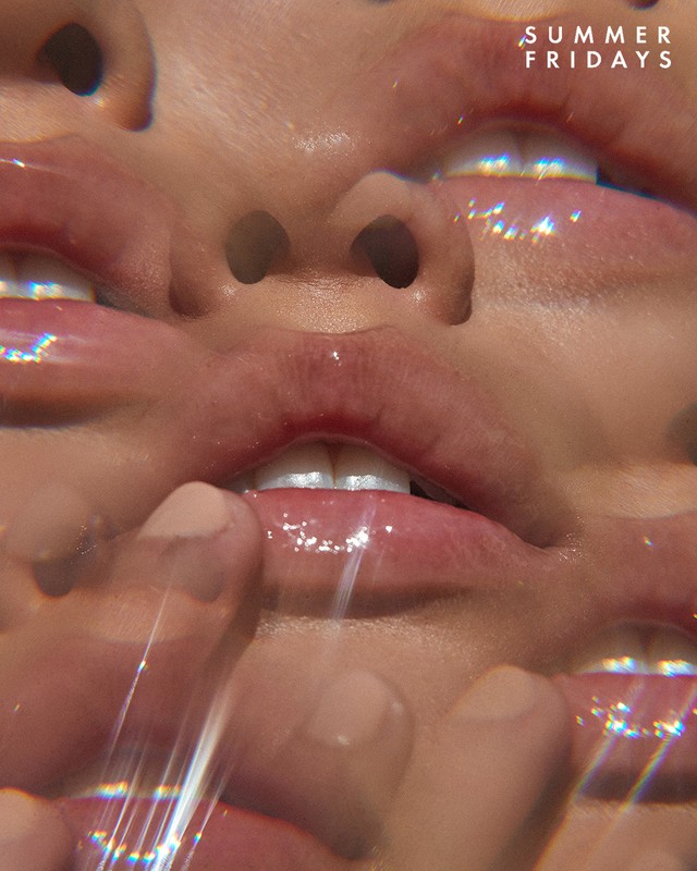 Macro shot of a woman's face with shiny lip gloss, illuminated by bright natural light, and the brand Summer Fridays visible.