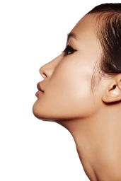Close-up profile of a woman with winged eyeliner and neutral lips against a white background