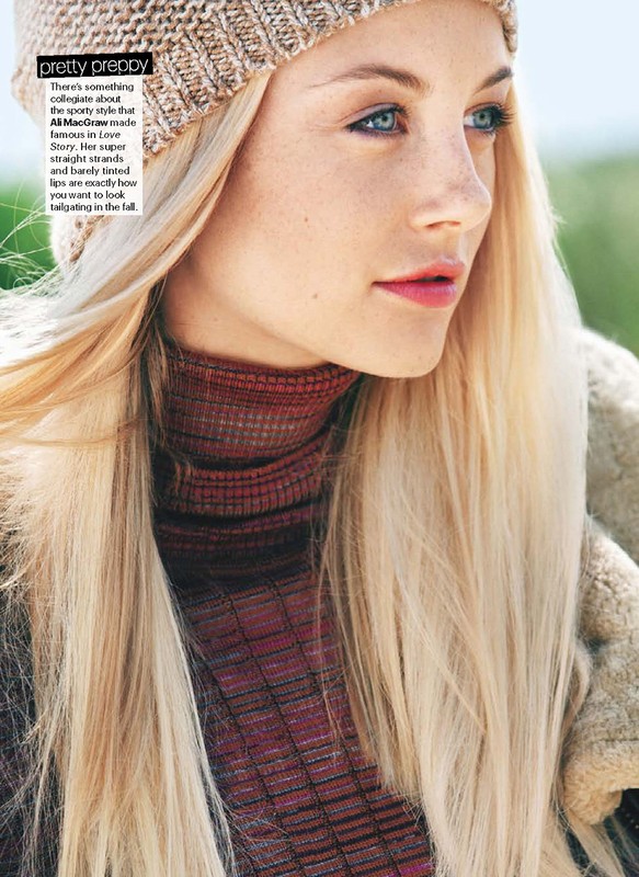 Portrait of a young woman with blonde hair wearing a beanie hat and turtleneck sweater, outdoors in soft, natural light.