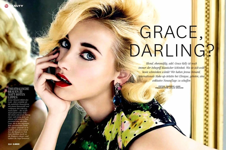 Beauty editorial of woman with blonde hair, red lipstick, and a floral top. Close up shot of model's face with hand near the mouth.