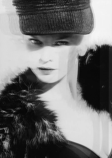 Black-and-white fashion portrait of a woman with a hat and fur collar, featuring dramatic lighting and a posed expression.