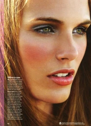 Close-up beauty portrait of a woman featuring shimmering metallic silver eyeshadow and rosy blush by makeup artist Jenna Menard.
