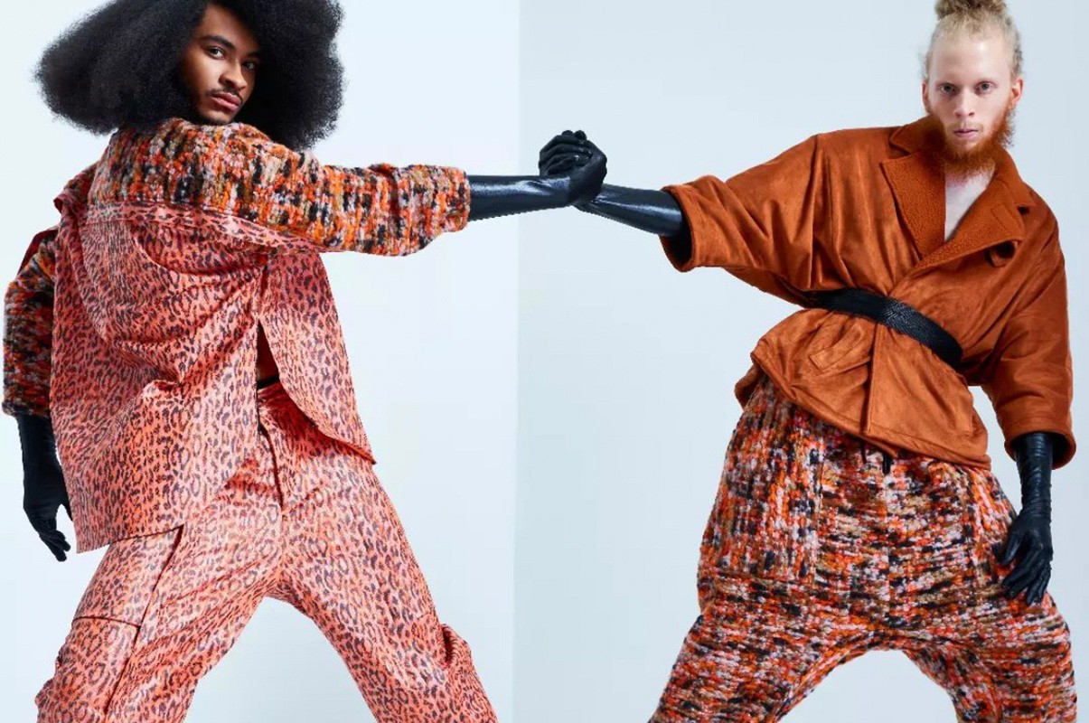 Two fashion models pose in brightly patterned outfits in a studio setting, showcasing contemporary fashion with bold colors and unique styles.
