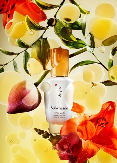 Cosmetic serum in a white bottle with orange flowers, green leaves, and white spheres against a soft yellow gradient background.