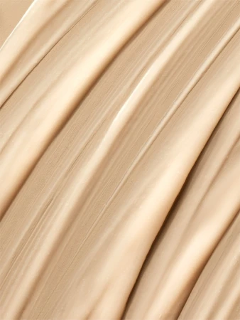 Close-up of smooth beige liquid foundation swatched in diagonal strokes, highlighting a creamy texture and matte finish.
