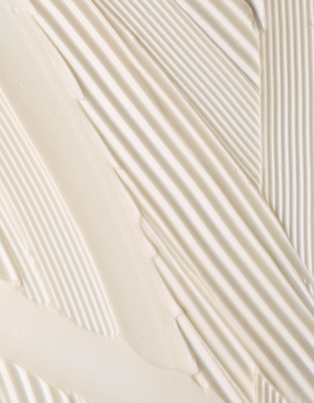 Close-up of thick, creamy, pale yellow textured strokes and ridges forming diagonal and vertical lines, creating a tactile visual.