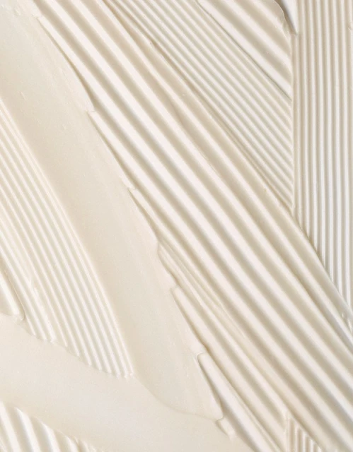 Close-up of thick, creamy, pale yellow textured strokes and ridges forming diagonal and vertical lines, creating a tactile visual.