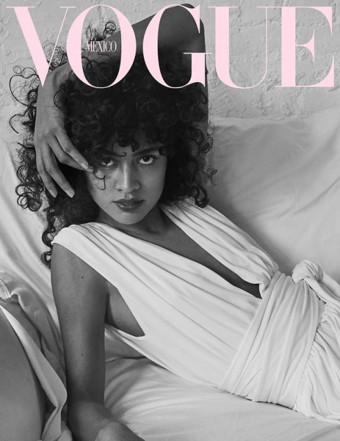 Vogue Mexico cover featuring a woman with curly hair in a white dress lying on a white surface with 'Vogue' text overlay.