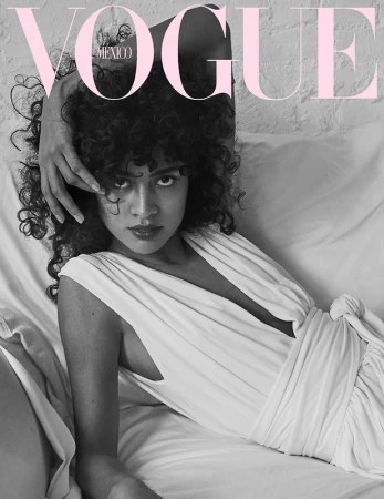 Vogue Mexico cover featuring a woman with curly hair in a white dress lying on a white surface with 'Vogue' text overlay.