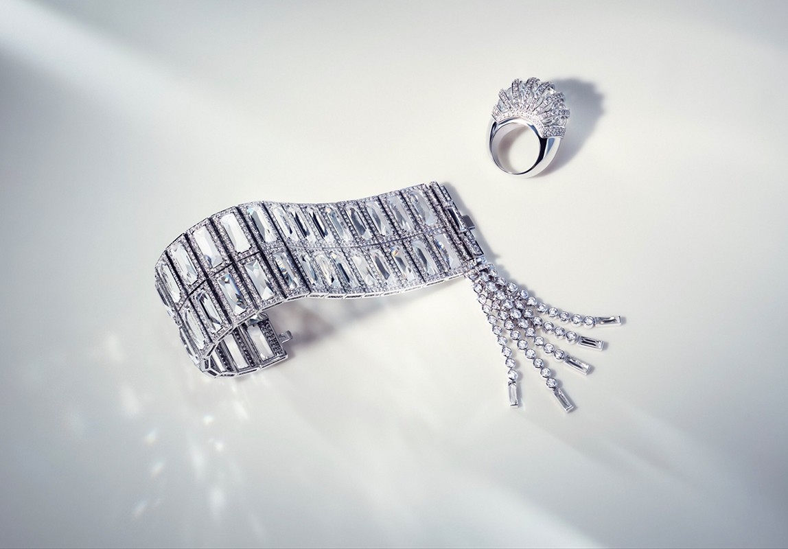 Elegant jewellery still life: A radiant diamond bracelet with tassels paired with a diamond ring on a clean, bright surface with soft lighting.