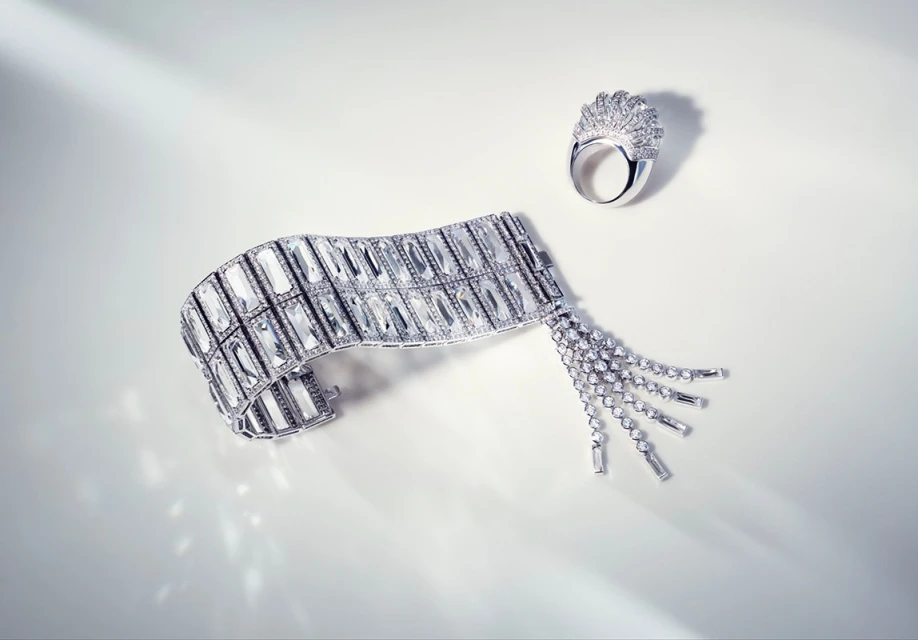 Elegant jewellery still life: A radiant diamond bracelet with tassels paired with a diamond ring on a clean, bright surface with soft lighting.