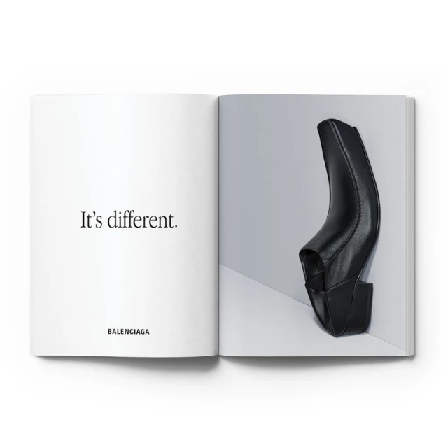 Open magazine with a Balenciaga black leather ankle boot featured on the right page and the phrase "It's different." on the left page.