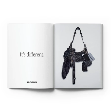 Open book spread features a Balenciaga bag on the right page, displayed against a white background, with text on the left page.