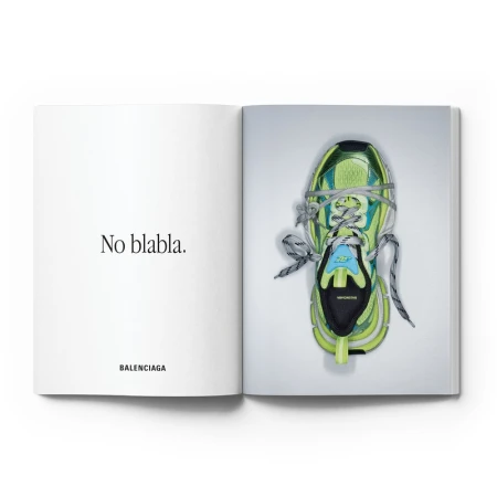 Open magazine showing typography on the left page and a green sneaker wrapped in string on the right page