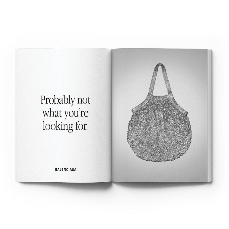 Open magazine spread with Balenciaga advertisement on one side and an image of a grey mesh tote bag on the other side.