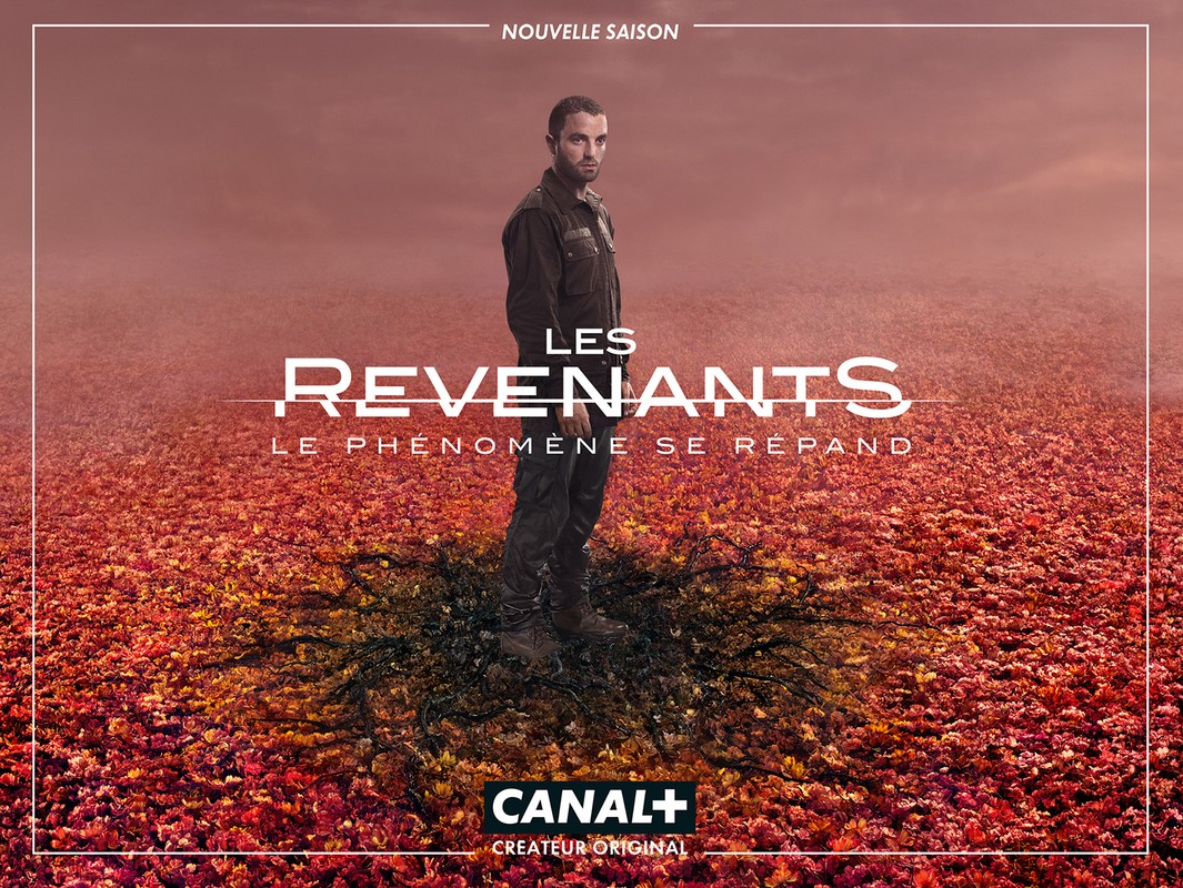 Poster image for the TV show Les Revenants (The Returned). Man in dark clothing stands in a field of red and orange leaves.