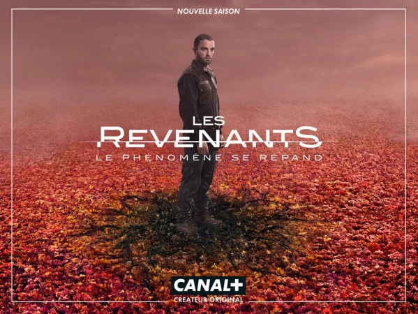 Poster image for the TV show Les Revenants (The Returned). Man in dark clothing stands in a field of red and orange leaves.