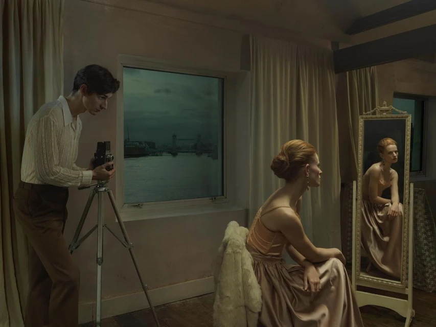 Indoor scene features a man photographing a woman near a window with a cityscape view and a mirror reflecting the woman seated.