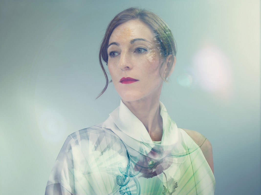 Portrait of a woman with red lipstick and layered floral and graphical double exposure elements by Julia Fullerton-Batten