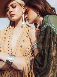 Two female models wearing fringed leather outerwear, lace garments, and silver jewelry in Los Angeles