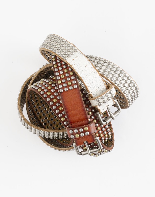 Three studded leather belts of brown and white colors with silver-toned buckles, coiled together on a white backdrop in a studio setting.