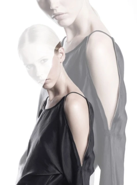 Fashion image of two women in sleeveless black dresses against a white background, showcasing a layered, artistic composition.