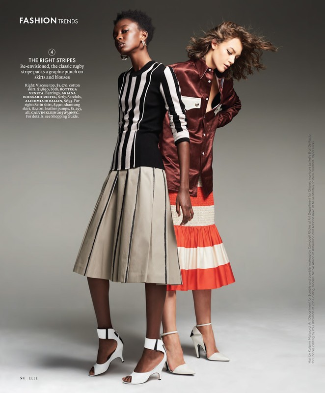 Two women model striped fashions: an African-American woman in black/white top and pleated skirt, alongside a Caucasian woman in orange.