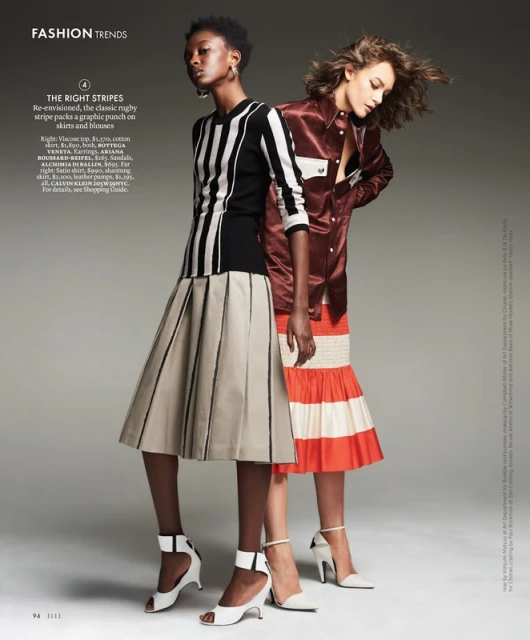 Two women model striped fashions: an African-American woman in black/white top and pleated skirt, alongside a Caucasian woman in orange.