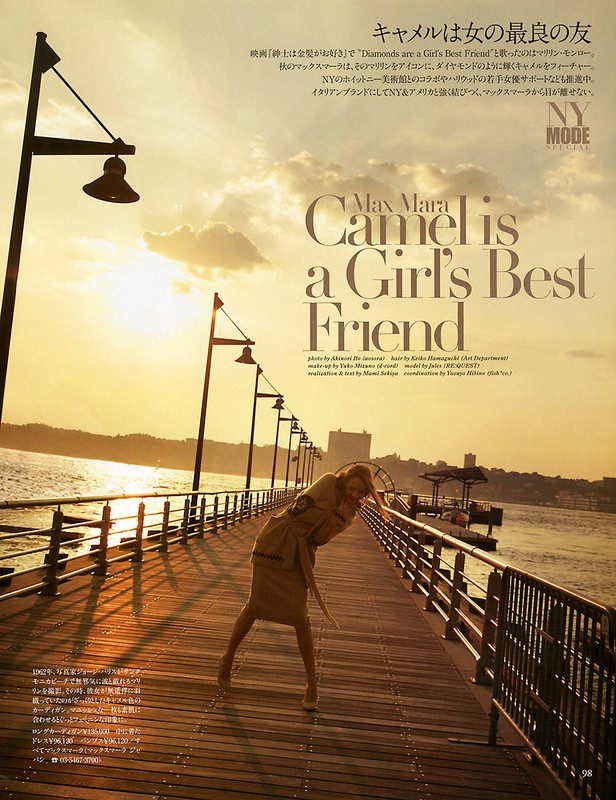 Fashion editorial shot on a pier at sunset features a blond woman in a trench coat, with the ocean and city skyline visible.