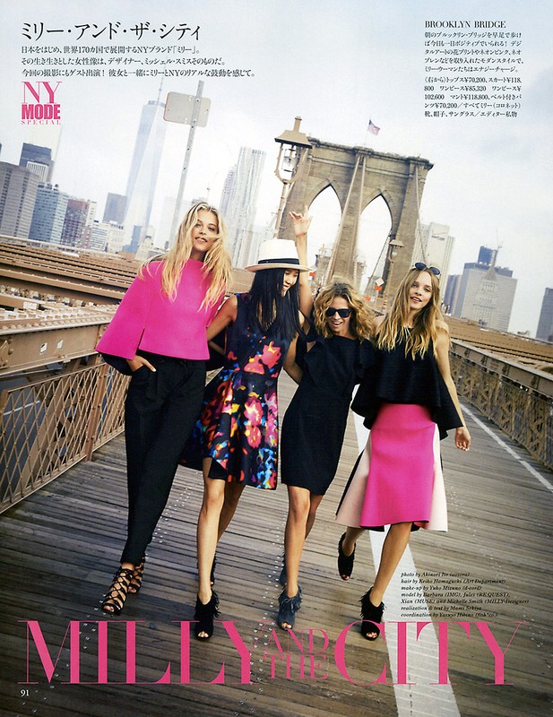 Four fashion models pose on the Brooklyn Bridge in New York City, wearing colorful dresses, skirts and tops, captured in a medium shot.