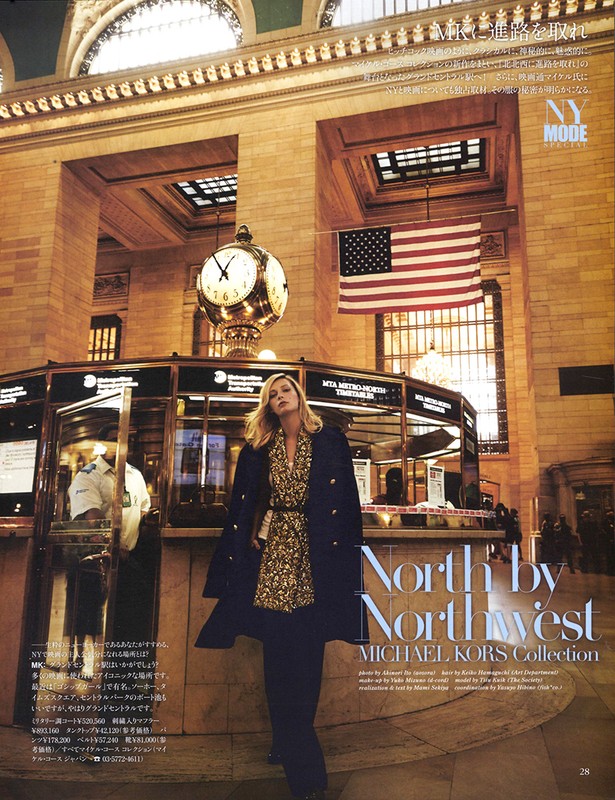 Editorial fashion shoot in Grand Central Terminal with woman in patterned dress, long coat, and dark pants in a large public space.
