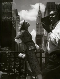 Monochrome editorial portrait of a woman in a tweed skirt suit and a man holding a small book in New York city street.